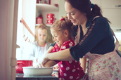 mom baking with daughters