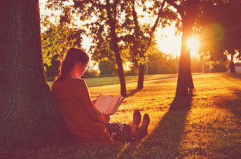 Girl reading by tree