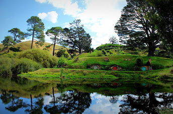 Huts from the Lord of Rings movie set can be seen popping out from the grass.