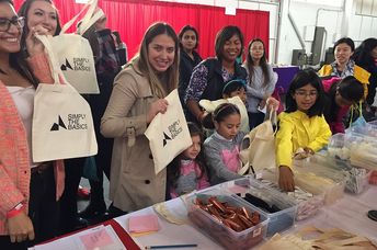 Simply the Basics volunteers help package hygiene kits. (Simply the Basics)