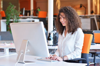 Happy woman at work (Shutterstock)