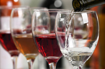 Wine being poured into wine glasses