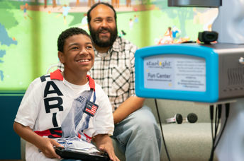 A boy in the hospital plays Nintendo.