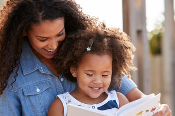 Mother reading epic books for kids  about women's history.