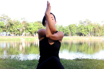 Woman in eagle yoga pose.