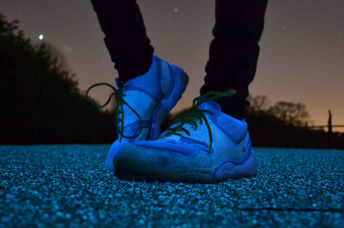 Jogger standing on solar-powered street lighting