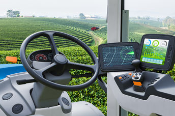 Autonomous tractor working in a green tea field.