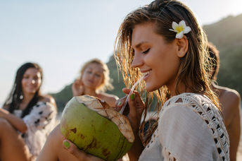 Drinking from a coconut.