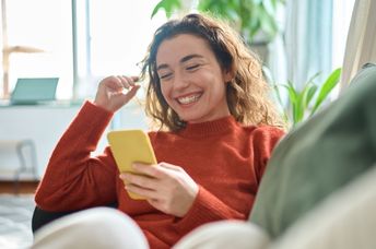 Happy and relaxed young woman working from home.