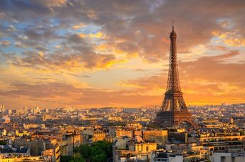 Skyline of Paris with the Eiffel Tower at sunset.