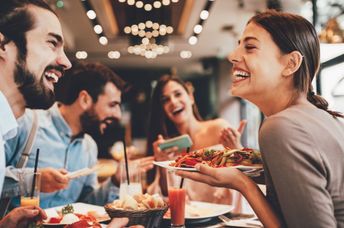 A group of happy friends eating out.