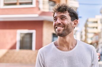 Young Spaniard walking along the street in the summertime.