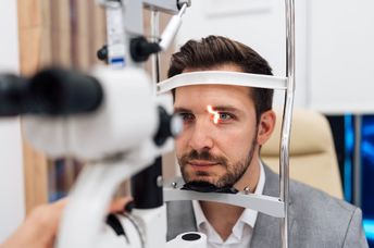 Ophthalmologist checking the vision of a patient.