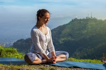 Practicing yoga in a spiritual setting.