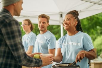 Volunteers feeding hungry people.