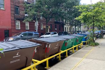 Curbside recycling and trash containers in NYC.