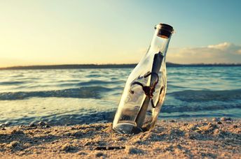 A message in a bottle on a beach.