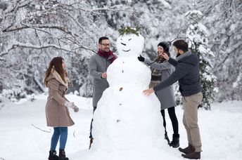 Friends building a snowman.