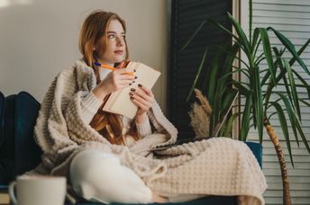 A woman writing in her journal.