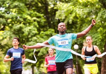 A runner crosses the finish line a ahead of his competitors