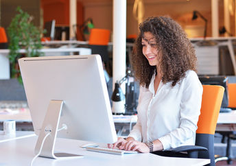 Happy woman at work (Shutterstock)