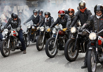 Members of motorcycle clubs ride together in large groups showing off their bikes