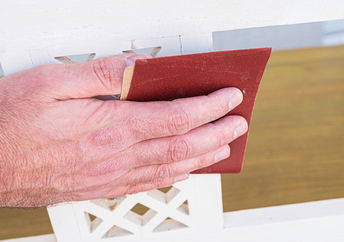 Man sanding a piece of furniture.