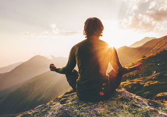 Man meditating outdoors.