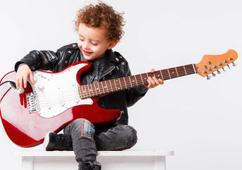 child playing an electric guitar.