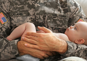 Soldier meeting his son for the first time.