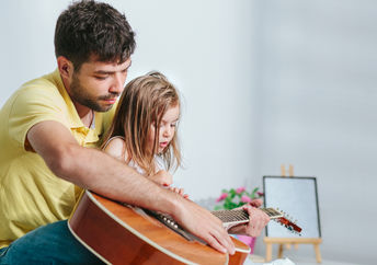 Dad singing to daughter.