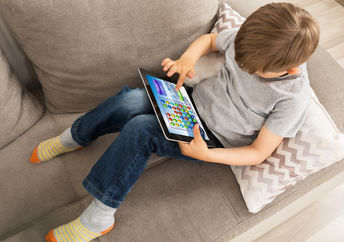 kid using an app on a tablet.