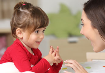 Mother and toddler conversing.