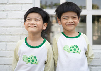 Smiling Asian twin boys.