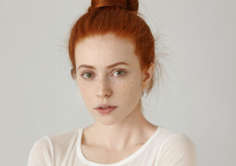 A portrait of a redhead woman.