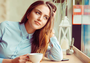 A young woman sitting in a cafe.