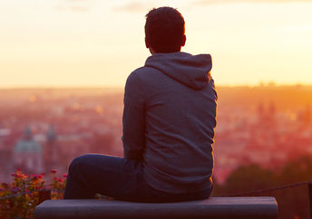 A man looking at the sunrise.