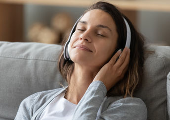 A young woman listening to music.