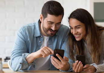 A couple using a smartphone.