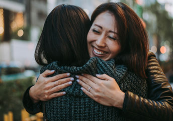 Two women hugging.