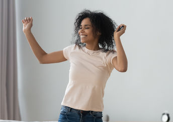 A woman dancing at home.