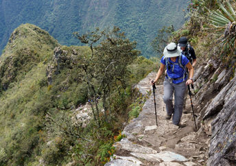 Two hikers walking on Inca trail of Machu Picchu.