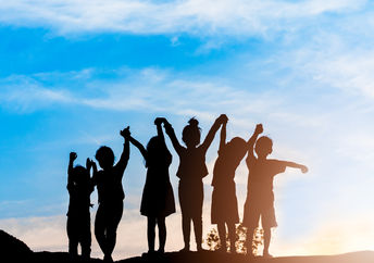 Silhouette of a group of children.