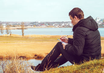 A young man writing a poem.