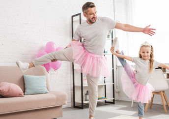 Father and daughter in pink tutu skirts.