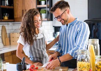 A couple cooking together.