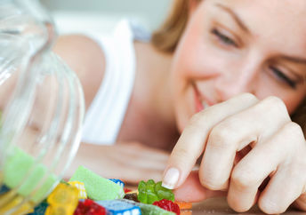 A woman eating jelly candies.