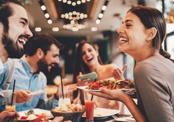 A group of happy friends eating out.