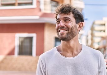 Young Spaniard walking along the street in the summertime.