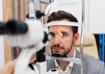 Ophthalmologist checking the vision of a patient.